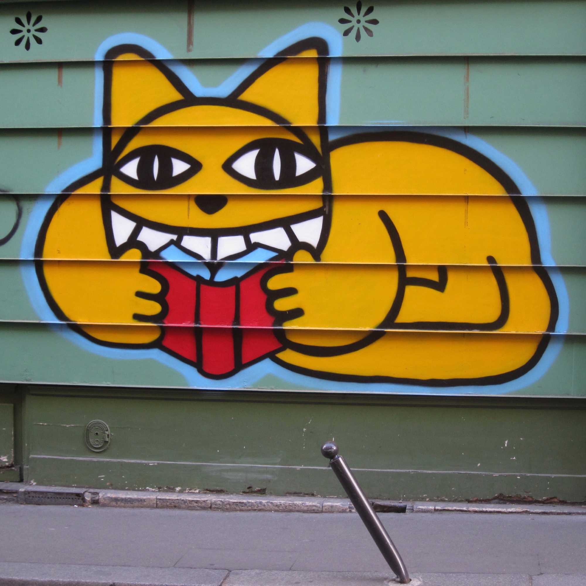Graffiti of a cat reading a book