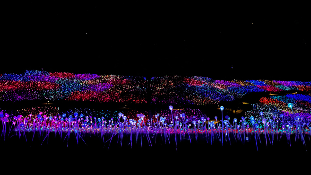 Dark hill covered in colorful lights